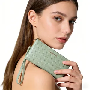 Detail of sage green woven clutch bag with gold zipper and Classic Star brand logo