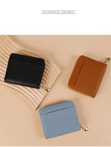 Litchi pattern leather zip wallets in black, brown and blue on wooden display tray