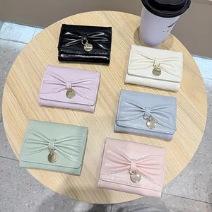 Portefeuilles à trois volets pour femmes en cuir PU avec nœud et pendentif en 6 couleurs