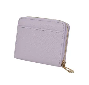 Detail of light purple litchi texture leather coin purse with golden zipper and card slot