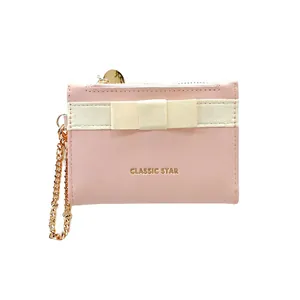 Pink macaron leather wallet with cream bow decoration and golden chain strap