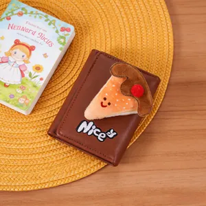 Detailed close-up of brown PU leather tri-fold wallet with plush cake patch and Nice embroidery