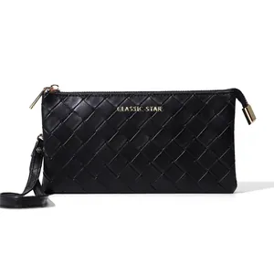 Classic black woven texture clutch bag with golden zipper and wrist strap on white background