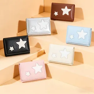Group display of star-patterned tri-fold wallets in various pastel colors on a clean stage