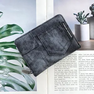 Close-up of denim textured wallet featuring stitch detailing and Forever Sunshine fabric label