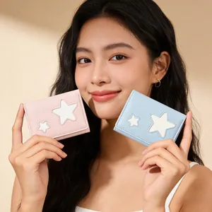 Close-up of pink and blue pastel bifold wallets featuring white star patches