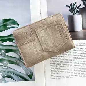 Close-up of khaki denim wallet with contrast stitching and Forever Sunshine plaque