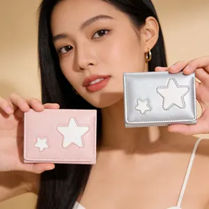Close-up of star embroidery detail on pink and silver compact tri-fold wallets