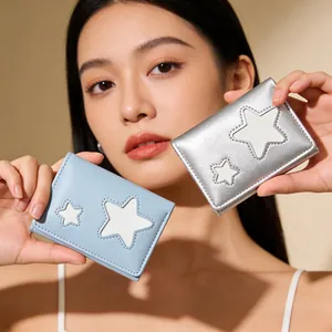 Detail view of light blue and silver cartoon star tri-fold wallets with neat stitching