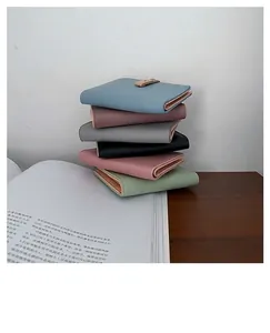 Group shot of colorful litchi grain PU leather short wallets with gold metal clasps