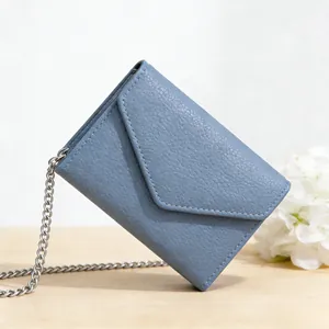 Detailed view of Morandi blue lychee leather mini envelope wallet with a silver chain