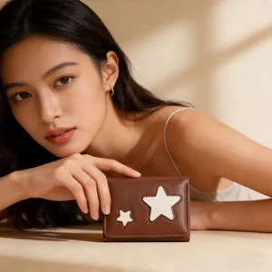Close-up of brown leather trifold wallet featuring white star patches and fine stitching
