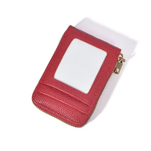 Detail view of red lychee grain card holder with clear ID window and gold zipper pocket