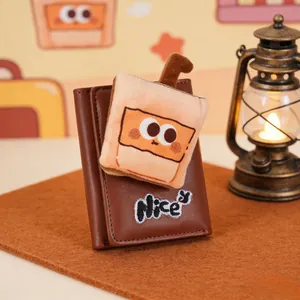 Detail of vintage brown trifold wallet featuring plush cartoon milk tea drink charm