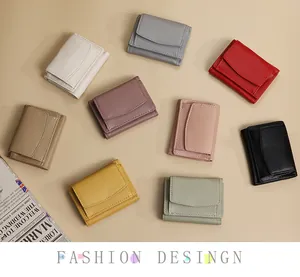 Detailed overhead view of mini litchi texture leather wallets in nine stylish colors