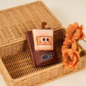 Detailed view of brown trifold wallet with plush milk tea charm and Nice embroidery