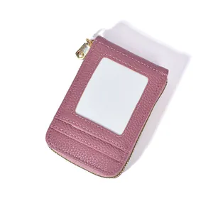 Detail of rose red leather card wallet featuring a clear ID window and gold metal zipper