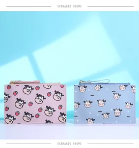 Slim cow print wallets in pink and blue with strawberry patterns and zipper closure