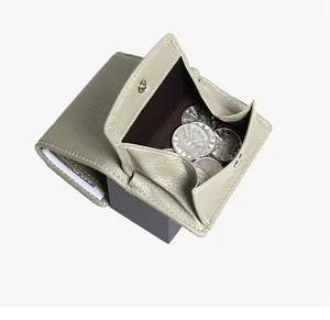 Detailed view of sage green lychee textured wallet with spacious coin compartment