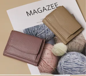 Close-up of lychee grain leather wallets with fine stitching on a magazine background