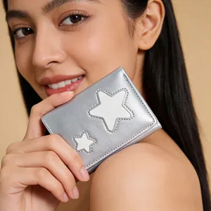 Detailed close-up of a silver metallic tri-fold wallet with white star embroidery