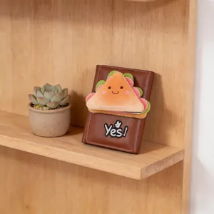 Brown leather wallet with cute 3D plush sandwich design and Yes embroidery on wood shelf