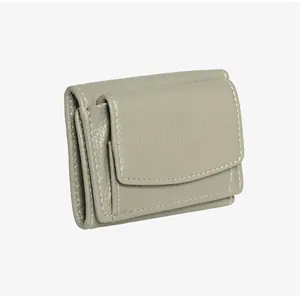 Close-up of sage green litchi texture leather wallet with white contrast stitching detail