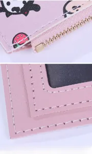 Pink leather wallet detail showing metal zipper and transparent card slot compartments
