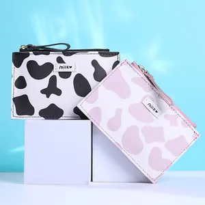 Cute cow print slim wallet set with milk logo and zipper on light blue background