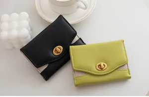 Close-up of minimalist tri-fold wallets featuring glitter trim and gold oval turn-lock