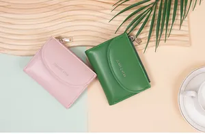 Close-up of pink and green matte leather wallets with classic star logo and metal zippers