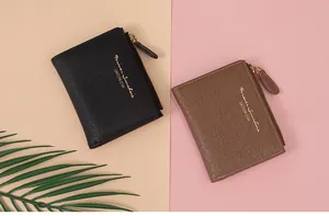 Top view of two crocodile texture wallets in black and brown with golden zipper detail