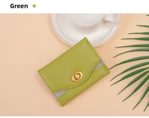 Detail of green tri-fold wallet with litchi texture and gold twist-lock closure