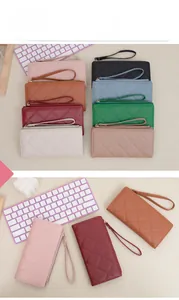 Detailed view of quilted long wallets in multiple colors with wristlet straps