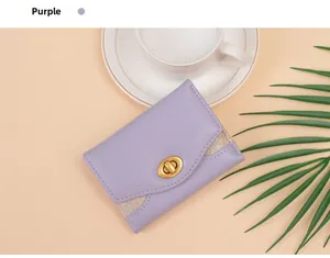 Detail of purple trifold wallet with gold turn-lock closure and glitter texture accents