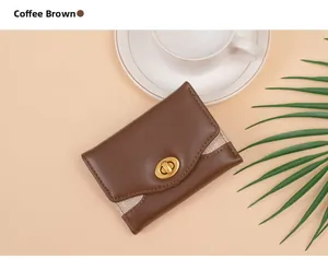 Detail of coffee brown trifold wallet showing golden glitter fabric and metal rotary lock
