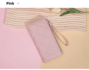 Detailed view of pink quilted long wallet with secure zipper and matching wristlet strap