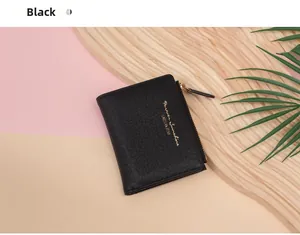 Detailed close-up of a black crocodile-textured short wallet with gold lettering