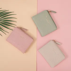 Three crocodile pattern short wallets in pink, green, and beige with zipper closure