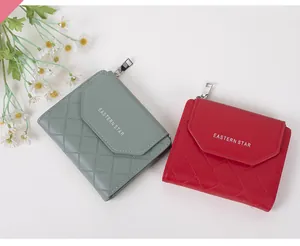 Flat lay of red and greyish green quilted leather short purses with chic daisy decoration