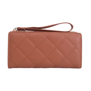 Quilted long zip wallet in caramel brown faux leather with matching wrist strap
