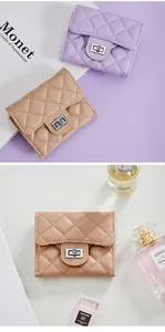 Detail showing quilted rhombus texture and elegant metal turn-lock of the women's wallet