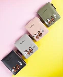 Close-up of four embroidered PU leather wallets with cute animal patterns and zipper strap