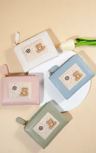 Overview of four cartoon bear wallets in beige, pink, blue and green with plush details