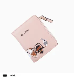 Close-up of pink faux leather wallet featuring cute animal embroidery and metal zipper