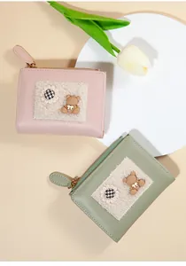 Detail of cute cartoon bear wallets with plush patchwork in pink and green colors