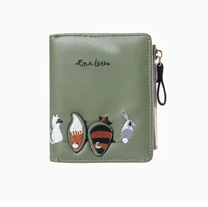 Close-up of grass green PU leather wallet with animal embroidery and one love text