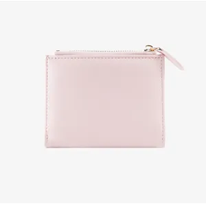 Detail of a minimalist pink PU leather wallet with smooth zipper closure and neat stitching