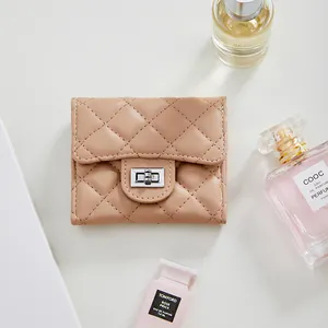 Elegant beige quilted leather wallet with silver metal clasp and luxury perfume decoration