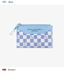 Detail of light blue checkered card holder with gold zipper and leather pull strap